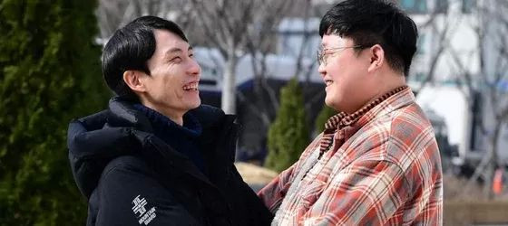 South Korean gay couple Kim Yong-min and So Sung-uk in a park.