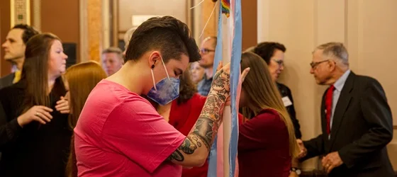 Executive director of Iowa Safe Schools Becky Smith raised a trans flag.