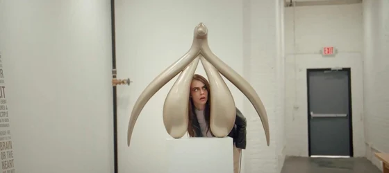 Non-binary genderfluid pansexual British model-turned-actress Cara Delevingne looking at a vagina statute.