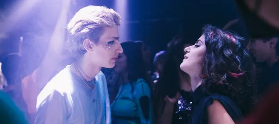 Mattia Carrano as Andrea dancing with Nina in an LGBTQ club.